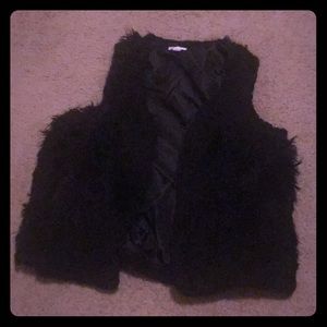 This is a black colored fall/winter fake fur vest